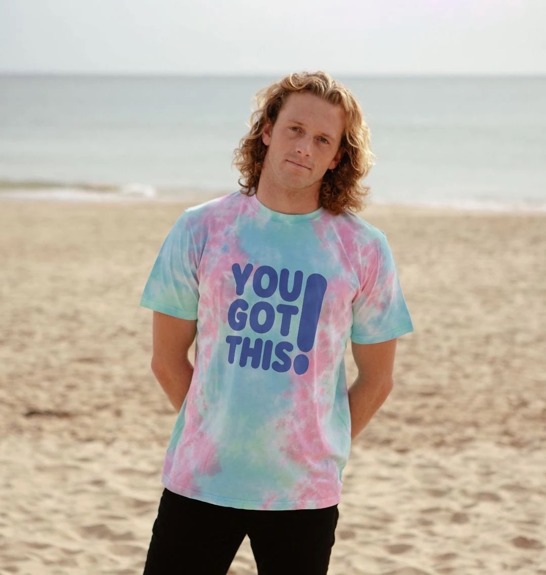 Model wearing our light blue and pink tie dye t-shirt with large navy You Got This logo across the chest.