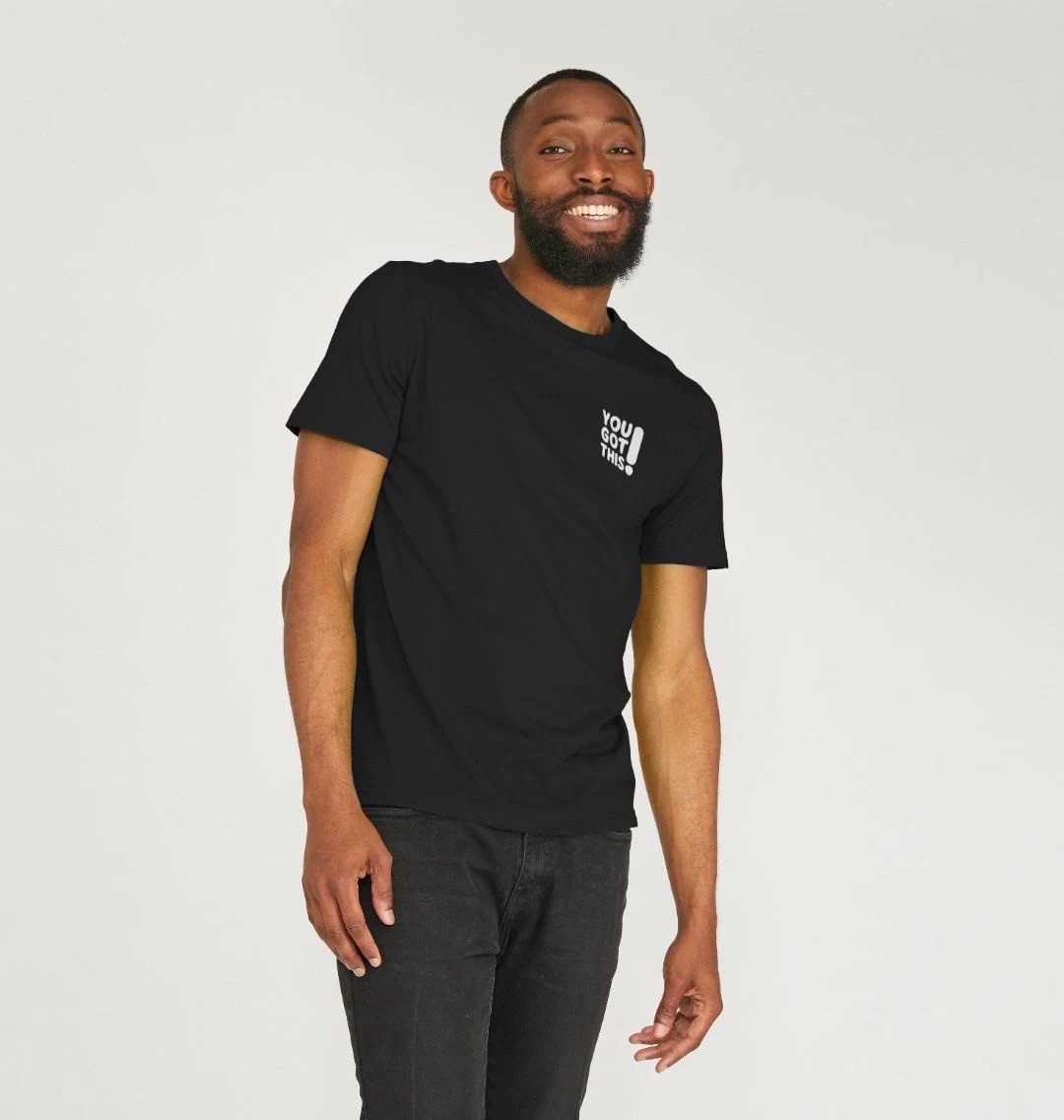 Model wearing a black t-shirt with a small white You Got This logo on the top-left chest.